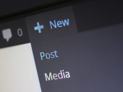 影刊编辑部内容主笔在书桌前整理影视评论手稿，台灯暖光下堆着分镜笔记与打印资料